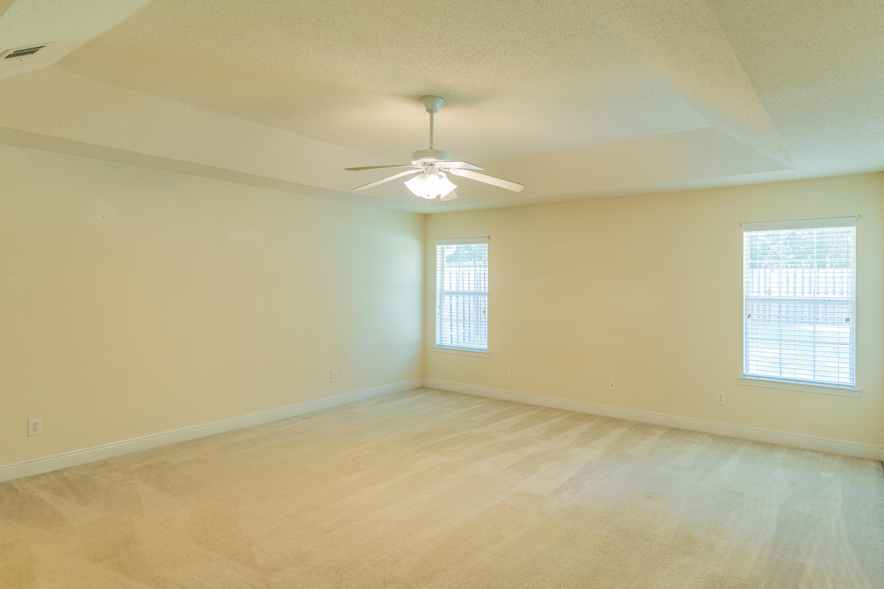 231 Foxchase Way Crestview, FL 32536 - Photo 21 of 30 an empty room with a window and a chandelier