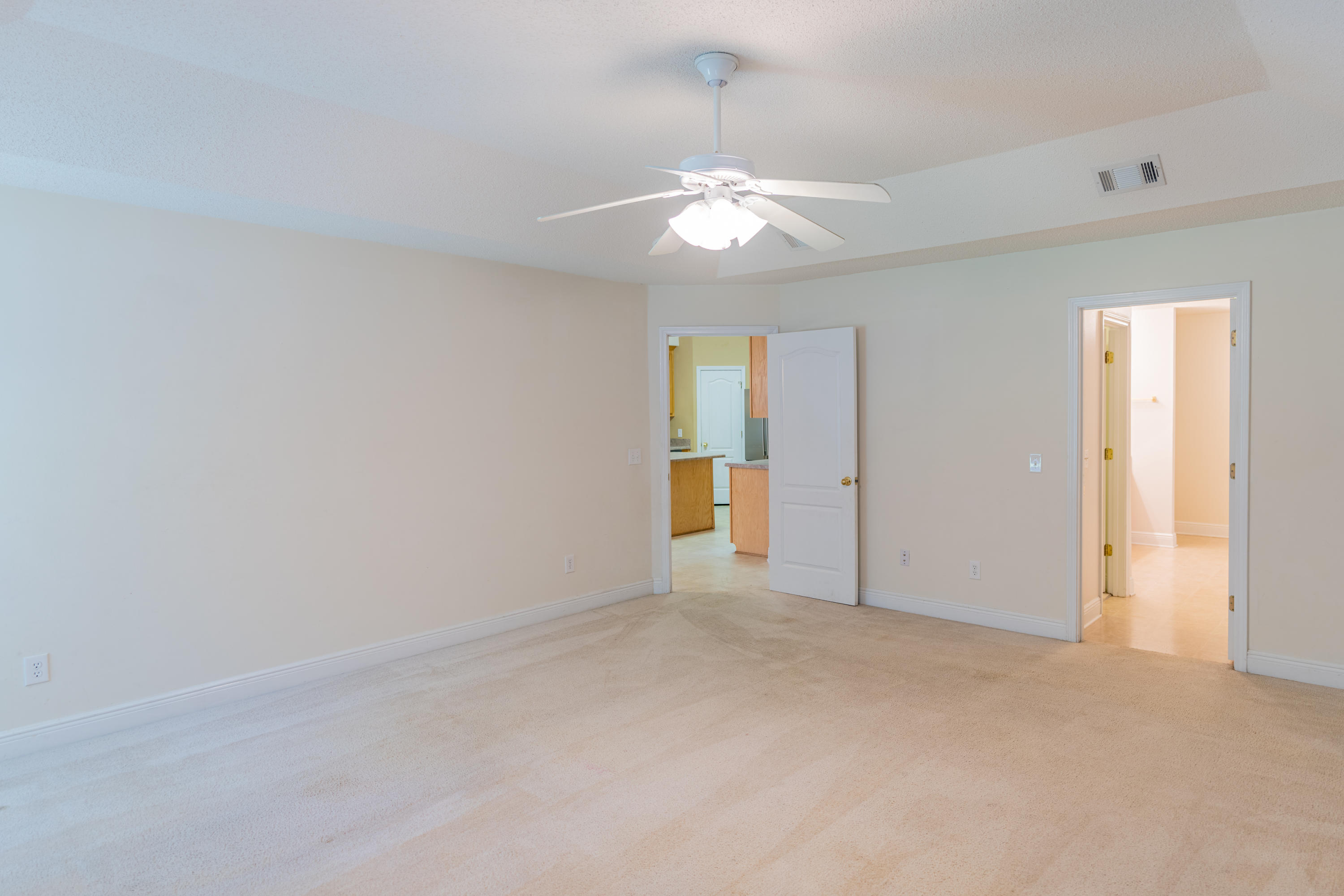 231 Foxchase Way Crestview, FL 32536 - Photo 23 of 30 an empty room with a chandelier fan and windows