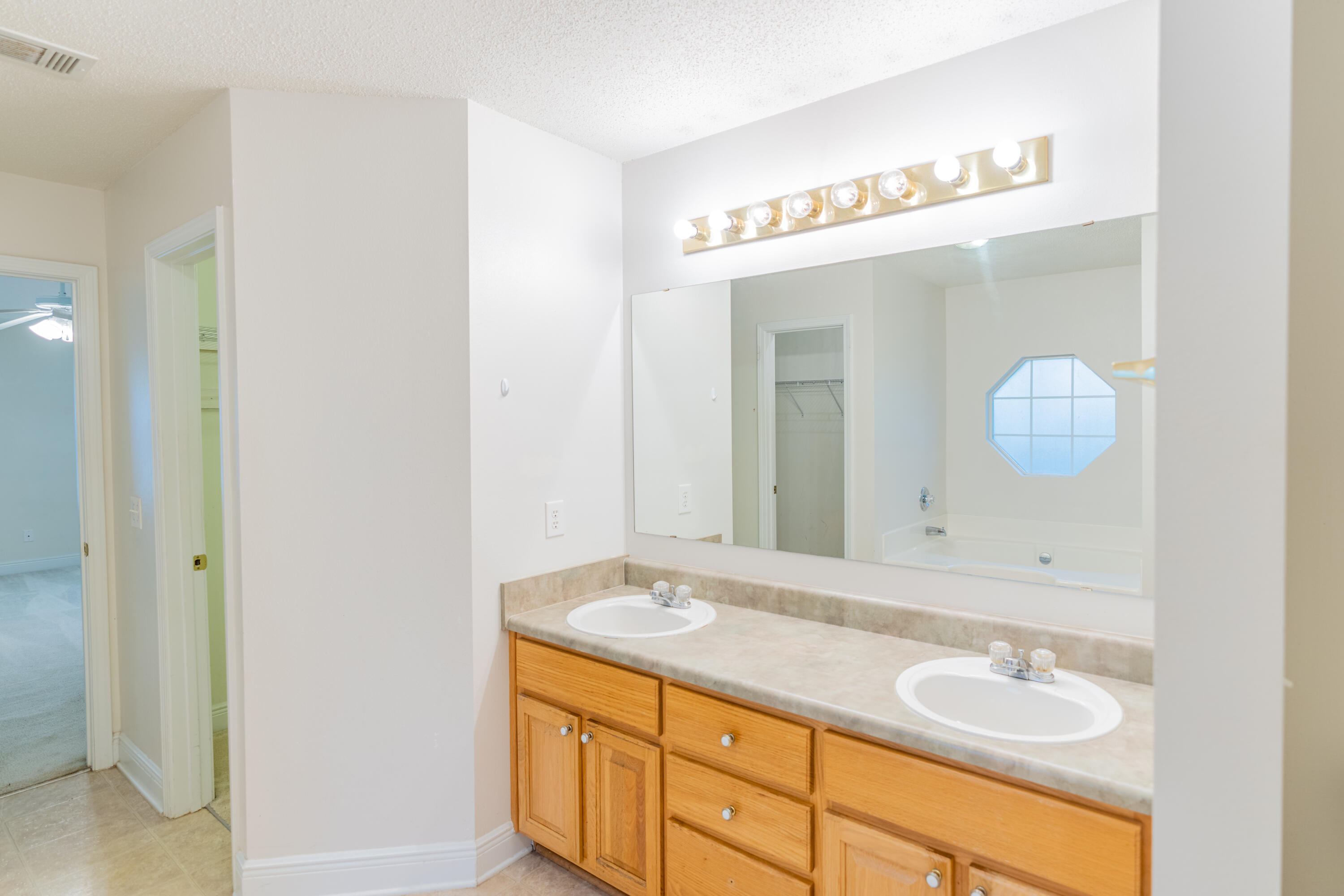 231 Foxchase Way Crestview, FL 32536 - Photo 24 of 30 a bathroom with a granite countertop sink and a mirror