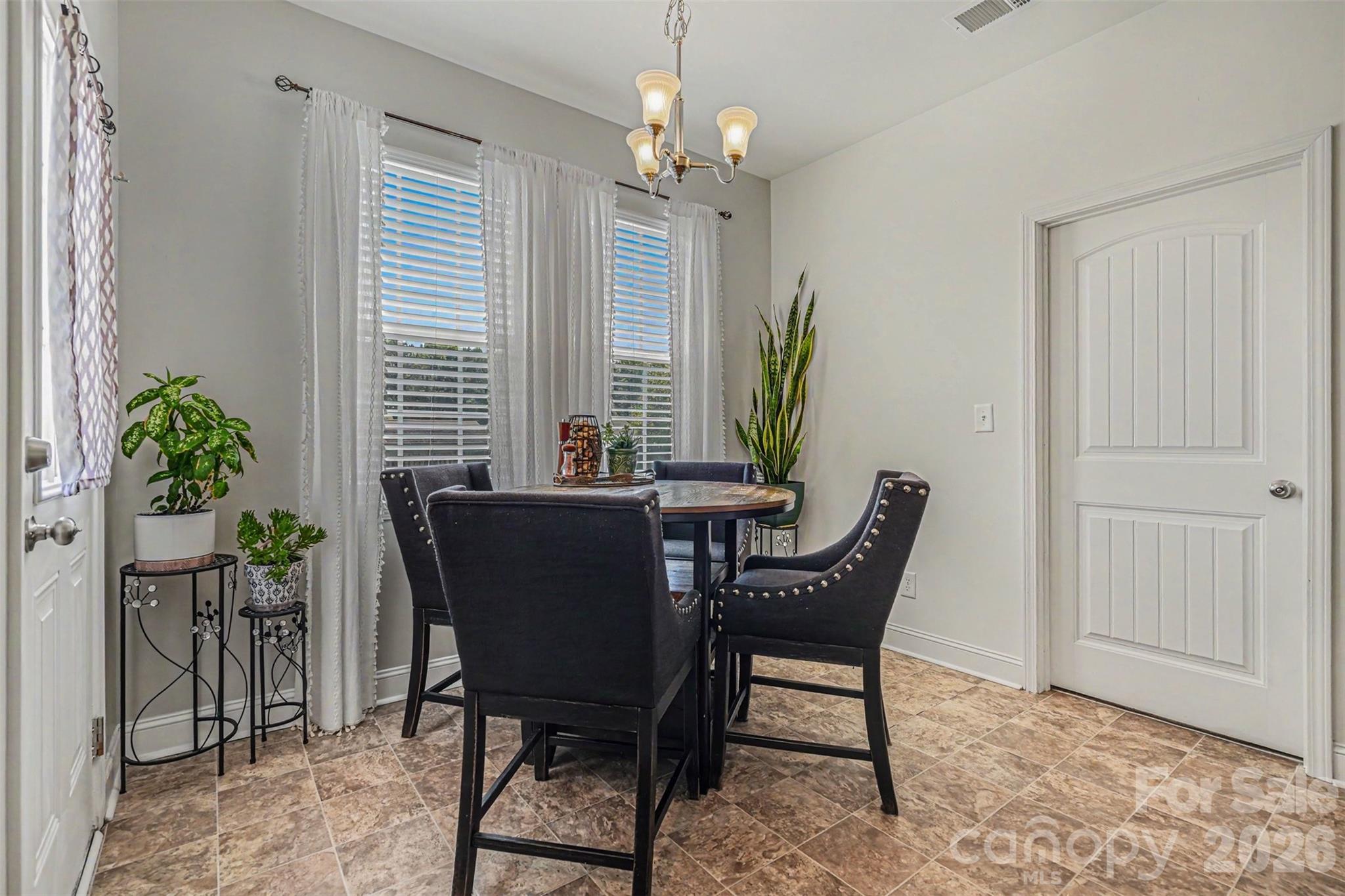 1610 Walter Hasty Road Monroe, NC 28110 - Photo 13 of 32 a view of a dining room with furniture and a potted plant