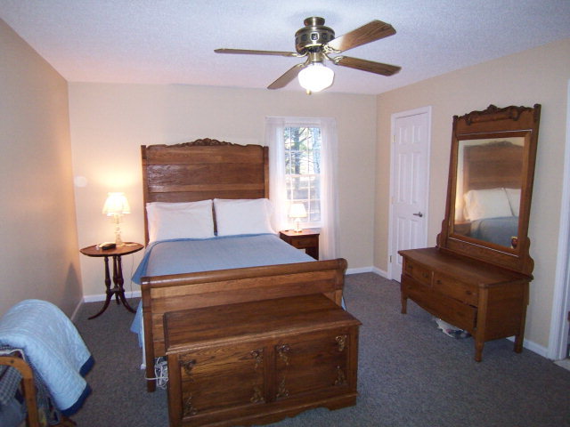 69 Lentz Road Macon, GA 31220 - Photo 5 of 12 a bedroom with a bed and a chandelier
