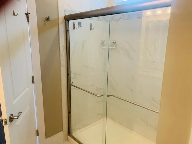 a bathroom with a glass shower door
