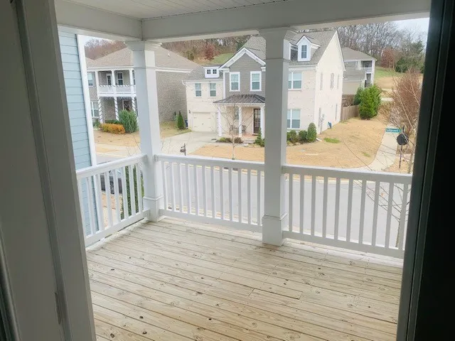 a view of a balcony with wooden floor