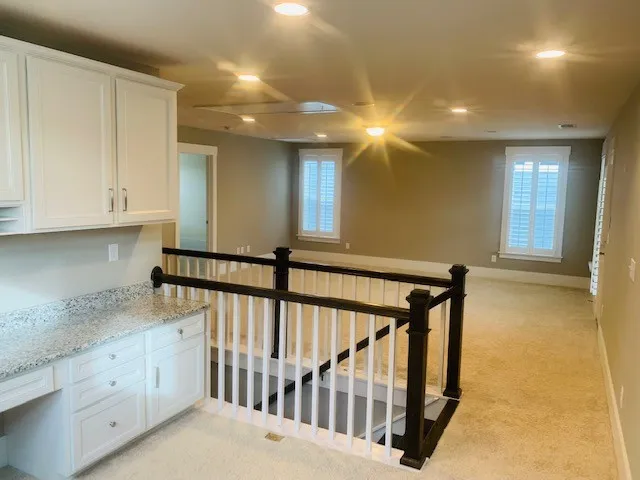 a view of staircase with white walls and a window