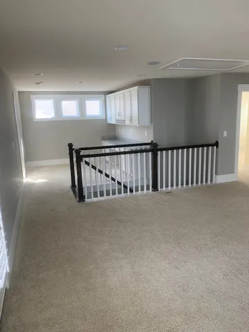 a view of an empty room with windows