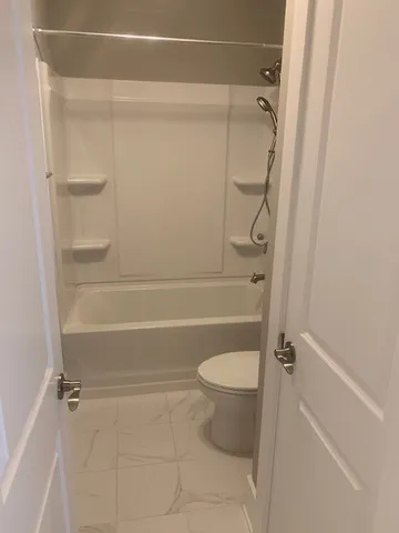 a bathroom with a shower and a toilet