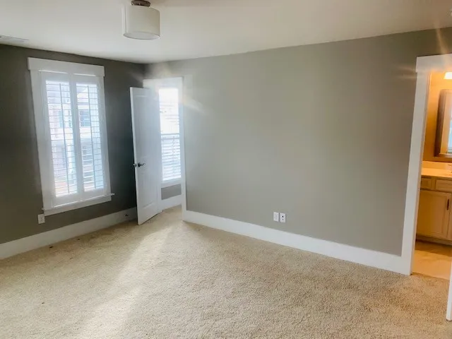 an empty room with windows and entrance