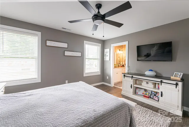 a bed sitting in a bedroom next to a window