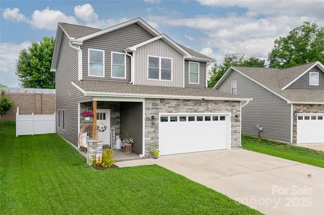 a front view of a house with a yard and garage