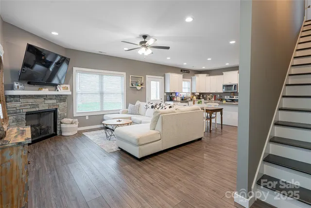 a living room with furniture a flat screen tv and a fireplace