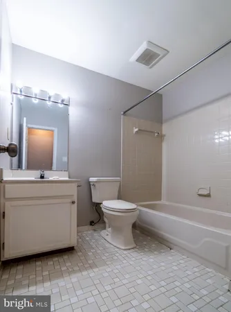 a bathroom with a toilet a sink and shower