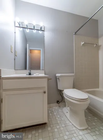 a view of an empty room with window and cabinet