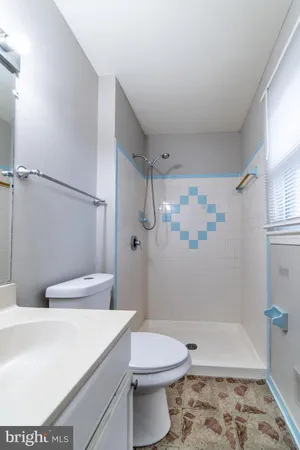 a view of empty room with window and fireplace