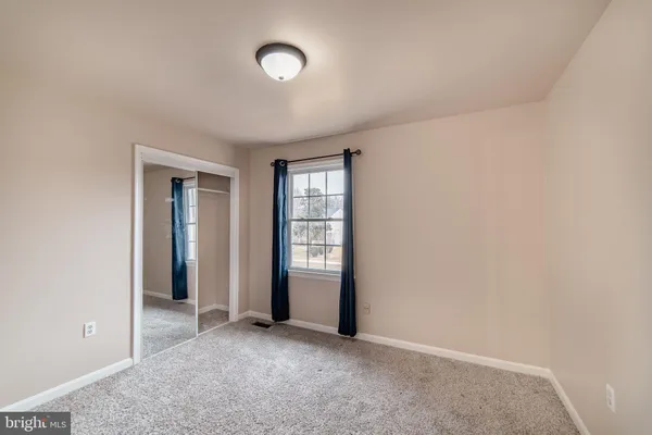 an empty room with closet area