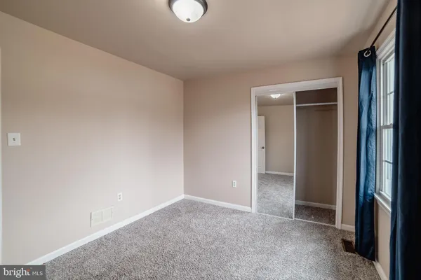 a view of a livingroom with a ceiling fan and window