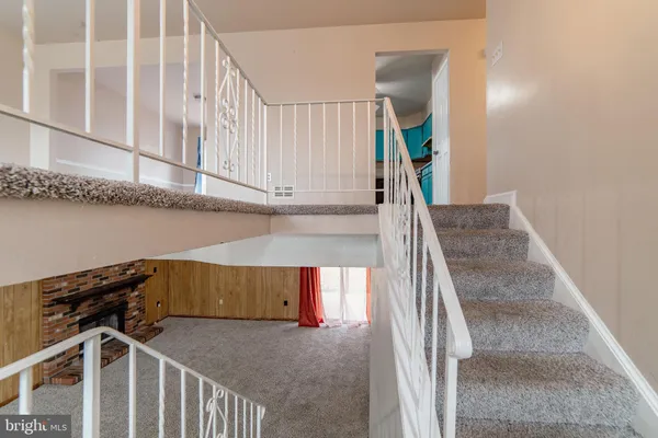 a view of a room with gym equipment and a large window