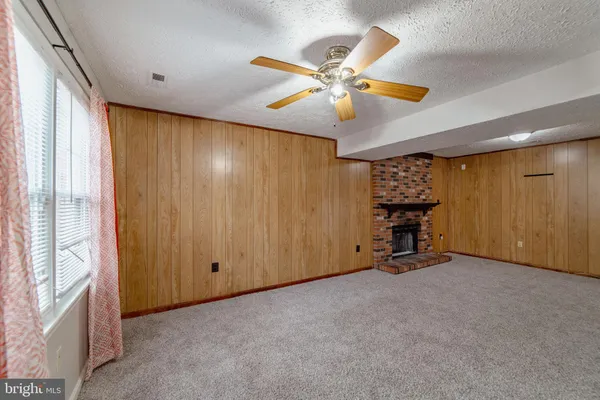 an empty room with furniture and a window
