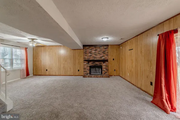 an empty room with window and cabinet