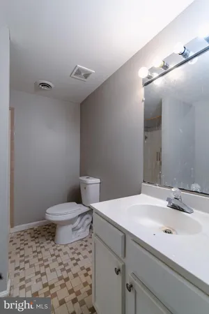 a view of a house with a large tree and wooden fence
