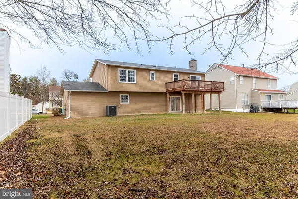 a tree in front of a white house