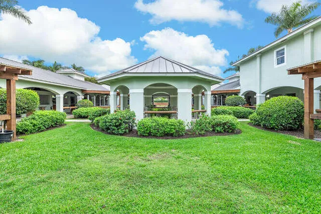 an aerial view of a house with swimming pool and outdoor seating