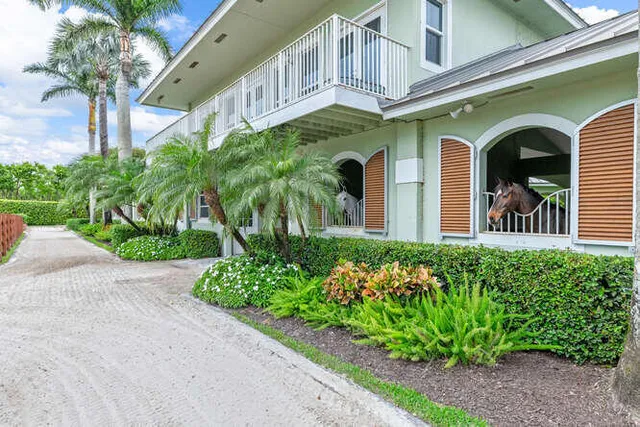 a living room with furniture a flat screen tv and a floor to ceiling window