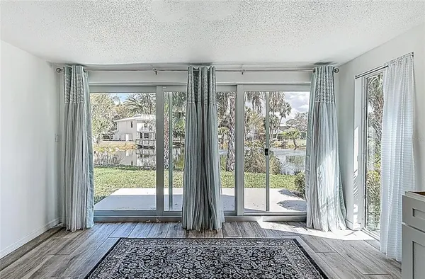 a view of a room with wooden floor and balcony