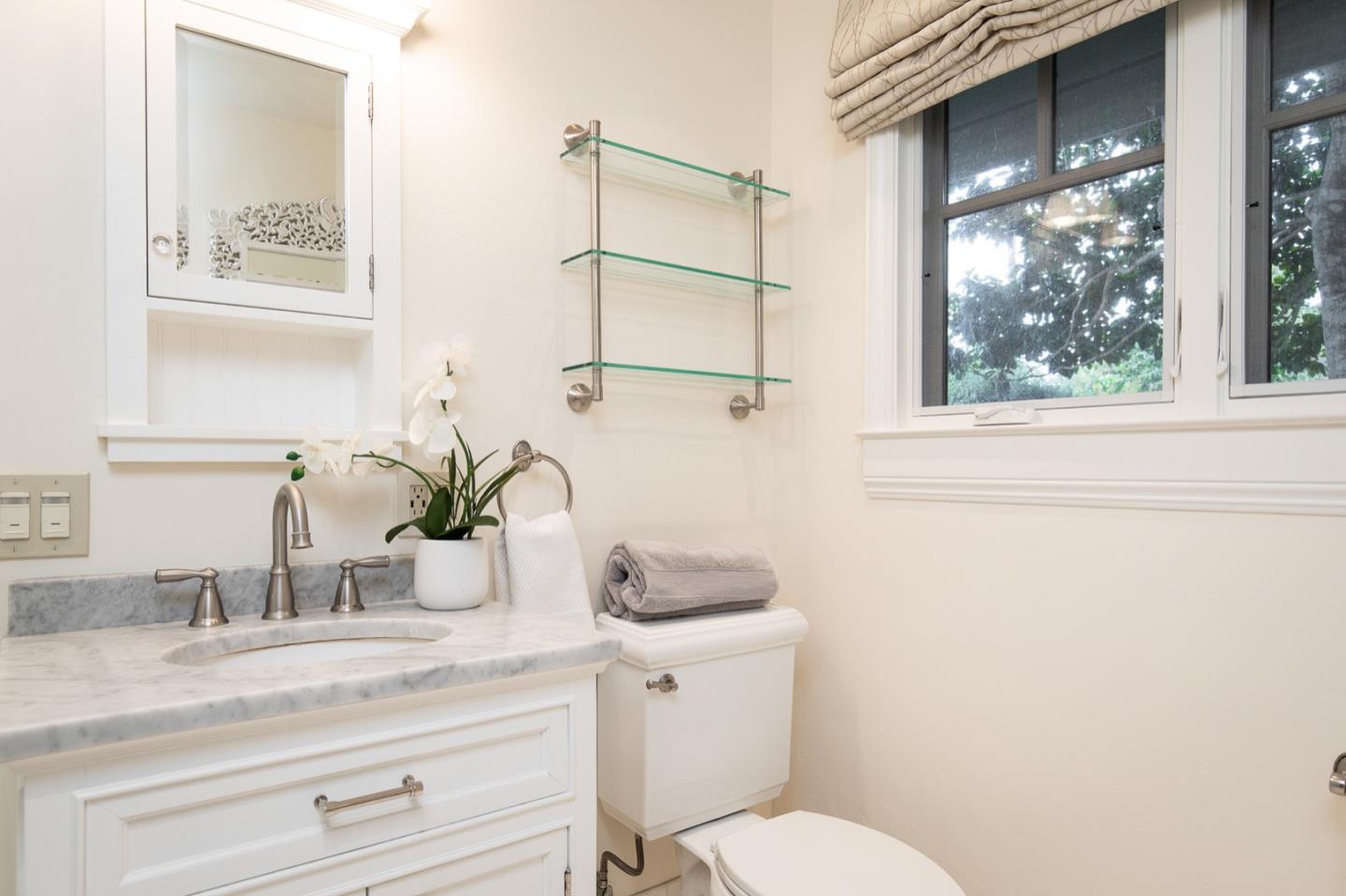 3115 Middle Ranch Road Pebble Beach, CA 93953 - Photo 16 of 19 a bathroom with a granite countertop sink mirror vanity and toilet