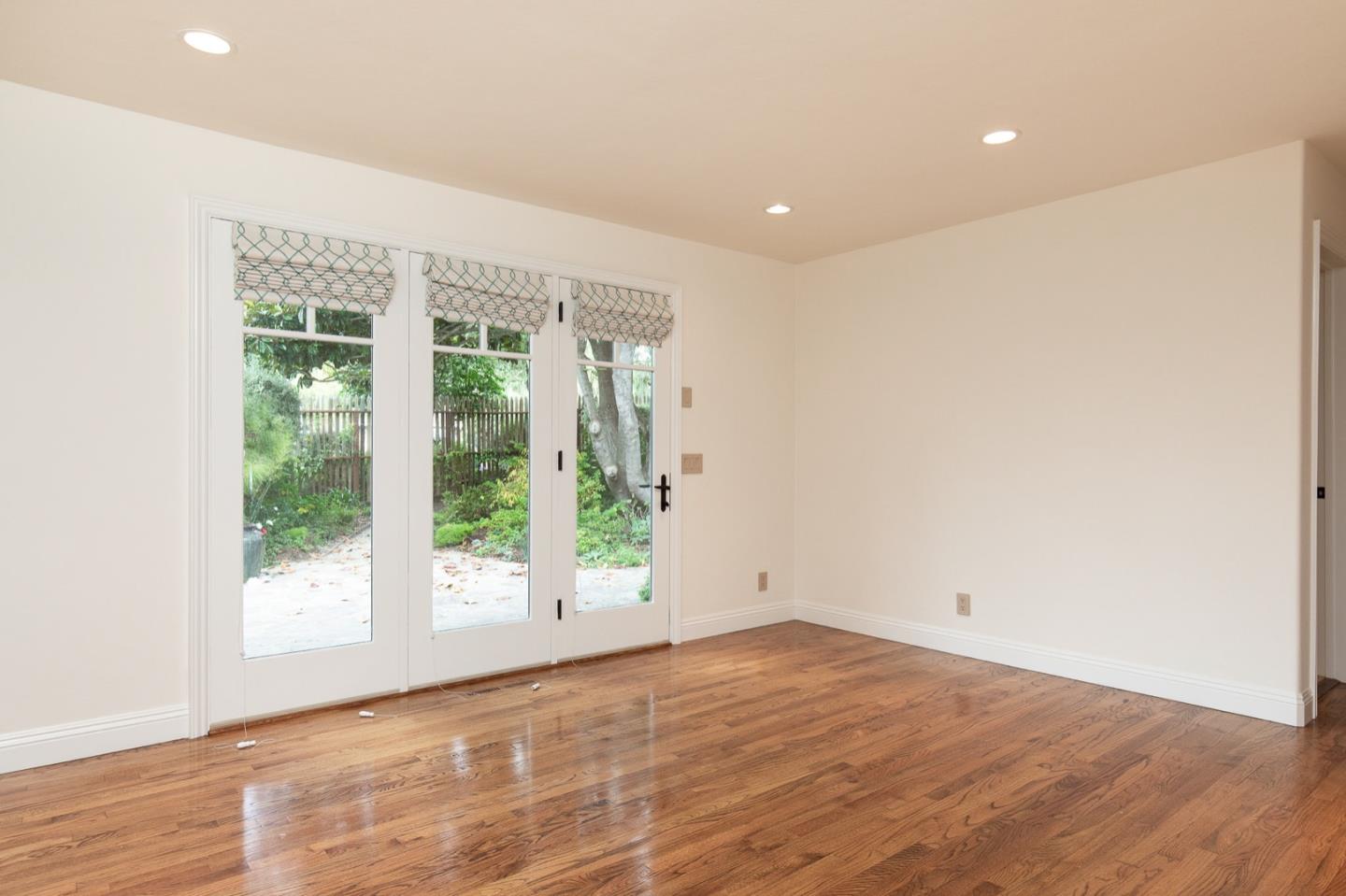 3115 Middle Ranch Road Pebble Beach, CA 93953 - Photo 17 of 19 an empty room with wooden floor and windows