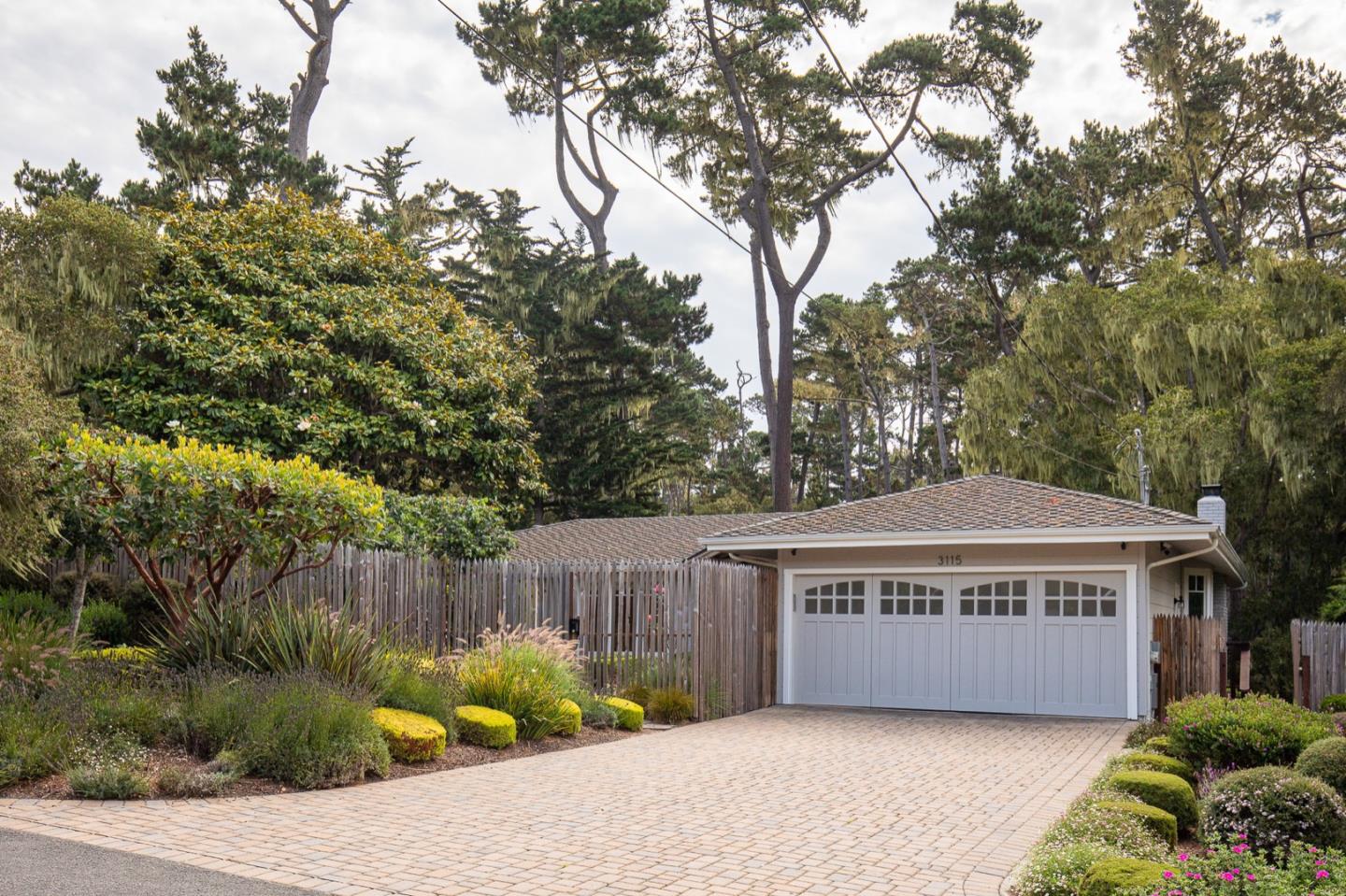 3115 Middle Ranch Road Pebble Beach, CA 93953 - Photo 19 of 19 a view of a house with a yard and potted plants
