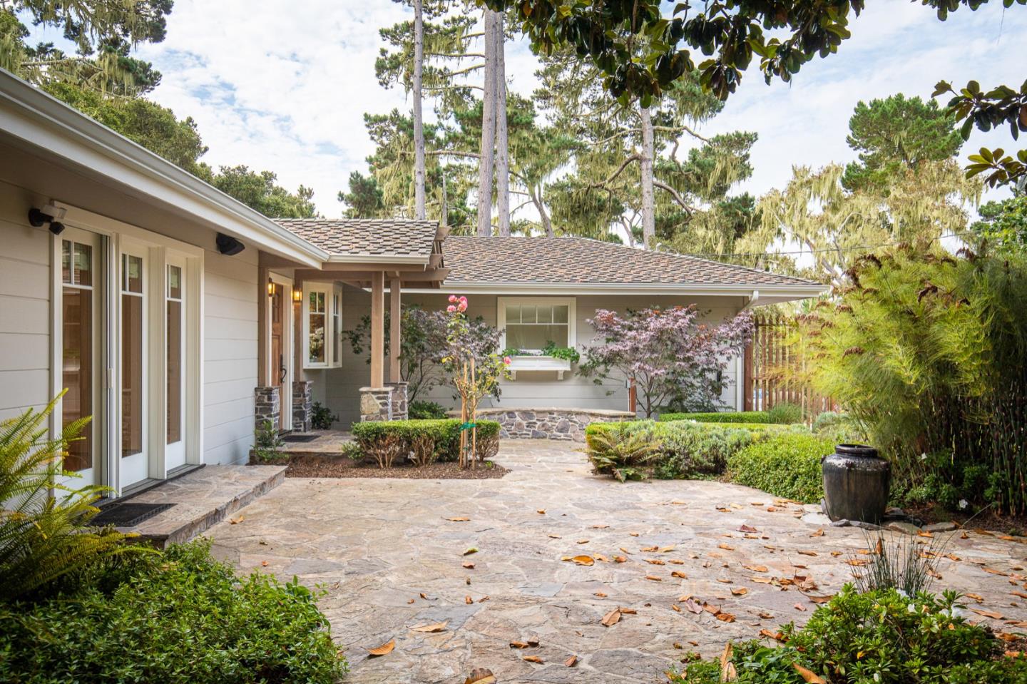 3115 Middle Ranch Road Pebble Beach, CA 93953 - Photo 3 of 19 a front view of a house with a yard and potted plants