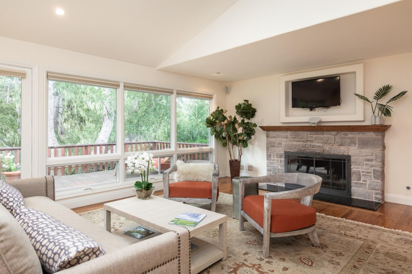 3115 Middle Ranch Road Pebble Beach, CA 93953 - Photo 5 of 19 a living room with furniture fireplace and a flat screen tv