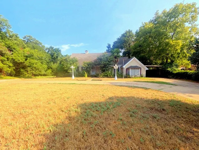 a view of walk in front of a house with a yard