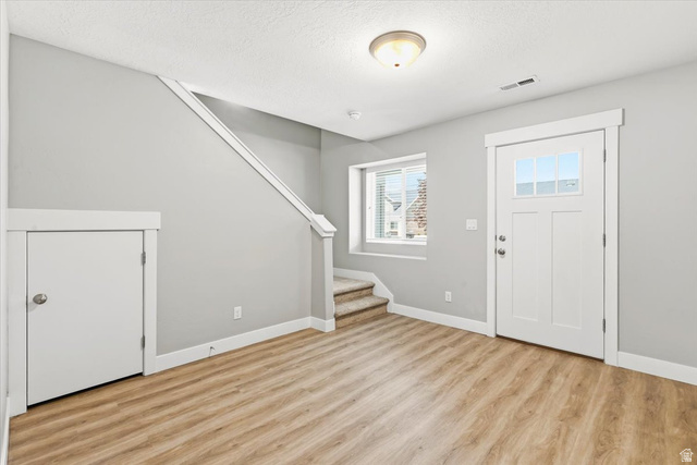 847 225 South Springville, UT 84663 - Photo 3 of 23 Entryway featuring a white paneled door with glass inserts, wood-finish flooring, a carpeted staircase, and a built-in storage closet