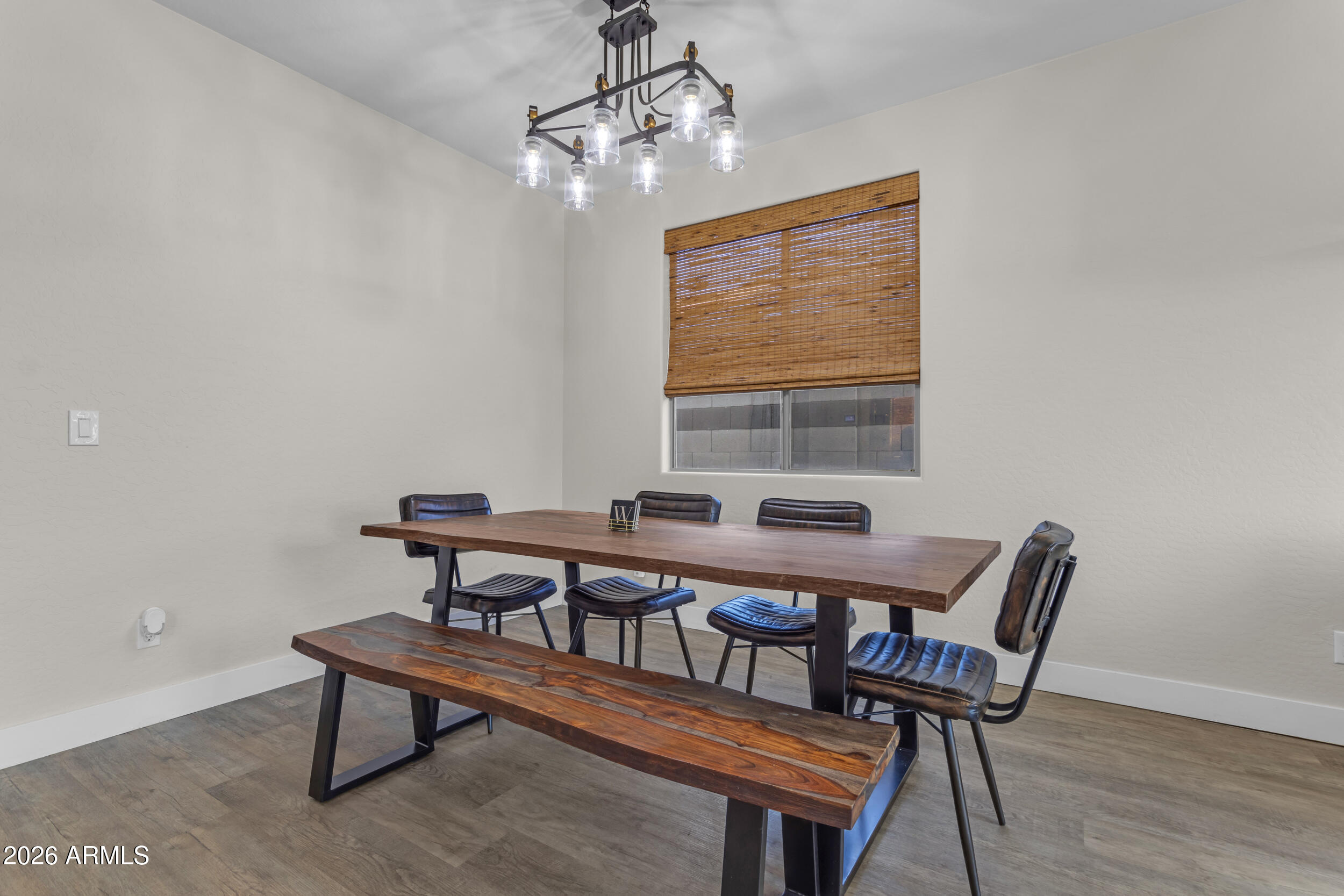 18115 West Cardinal Drive Goodyear, AZ 85338 - Photo 15 of 88 a view of a dining room with furniture window and wooden floor
