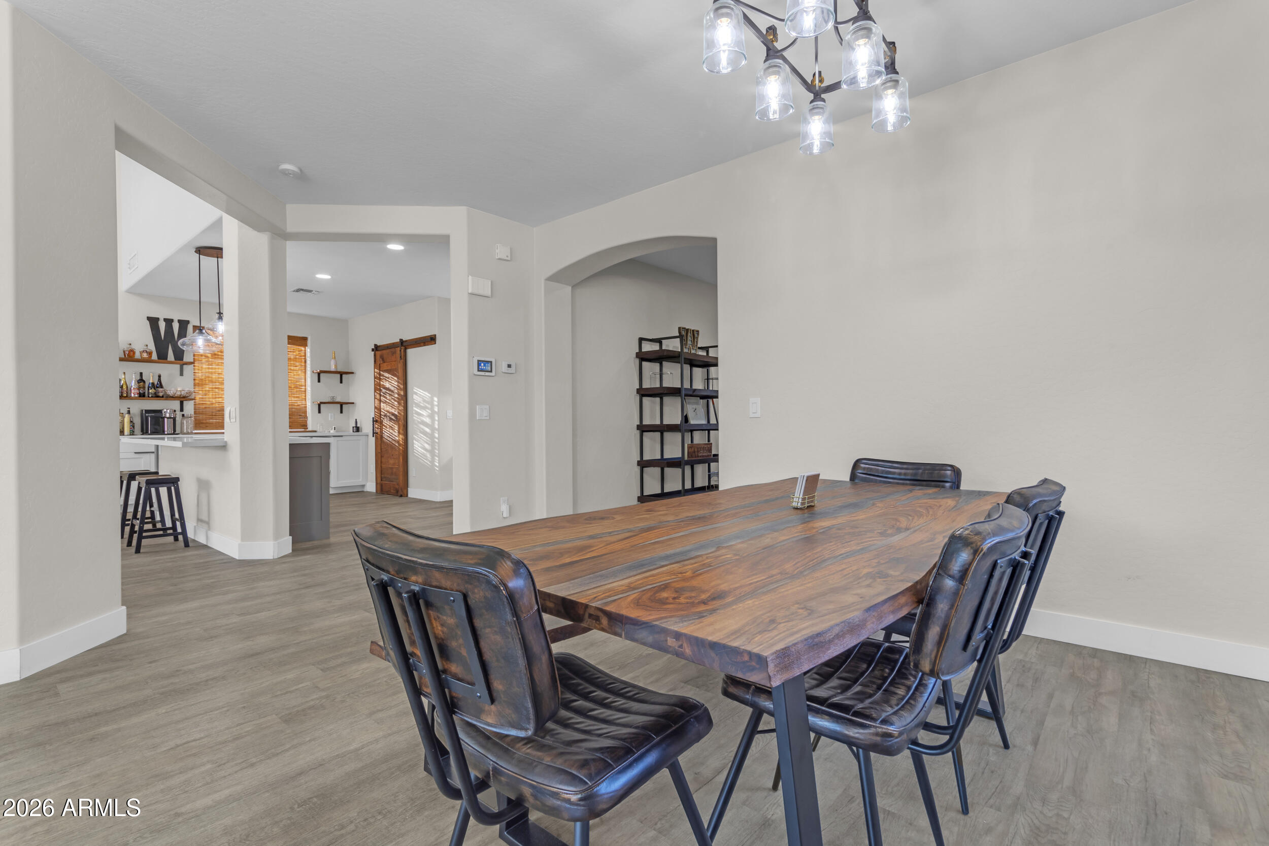 18115 West Cardinal Drive Goodyear, AZ 85338 - Photo 16 of 88 a dining room with furniture and wooden floor