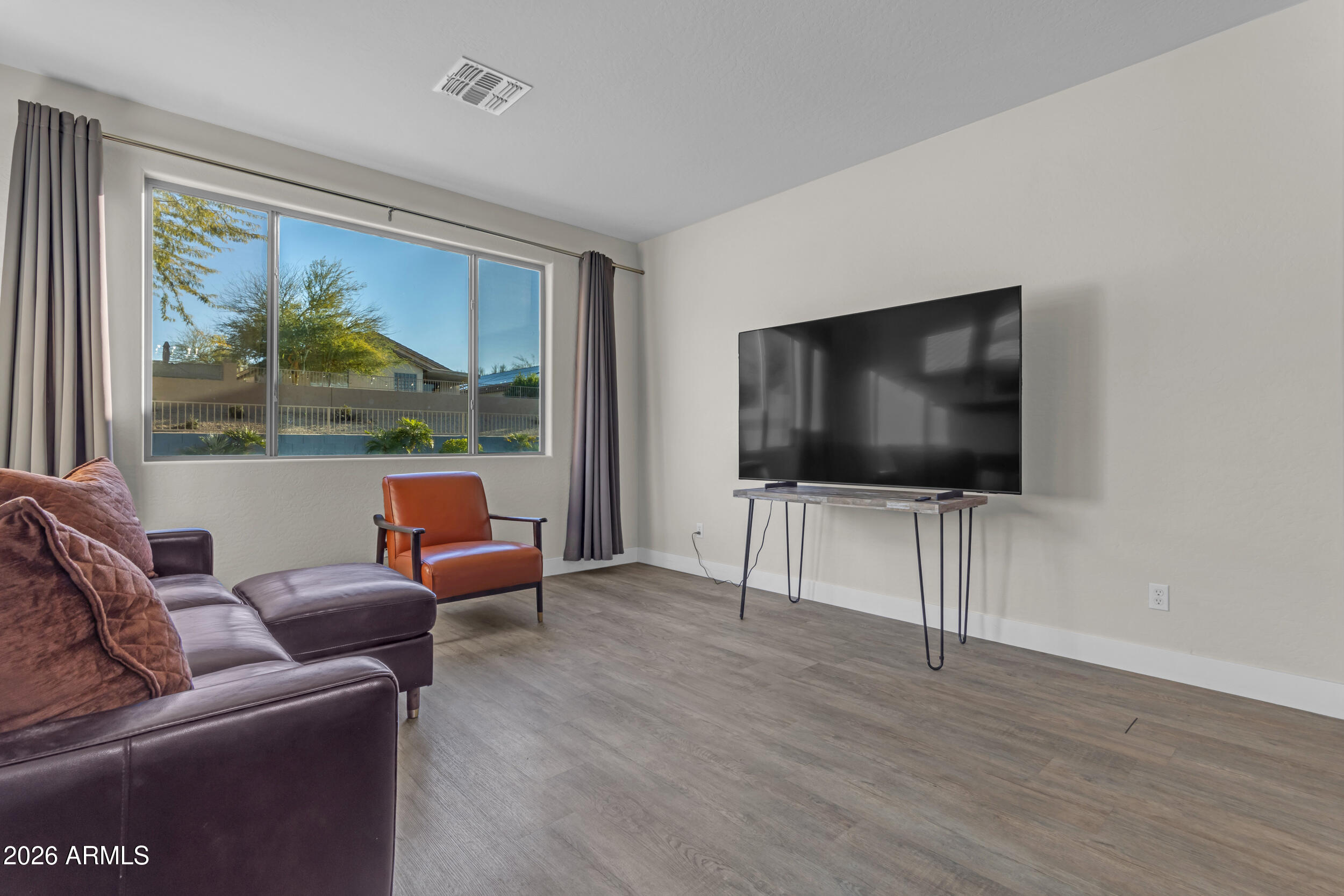 18115 West Cardinal Drive Goodyear, AZ 85338 - Photo 17 of 88 a living room with furniture and a flat screen tv