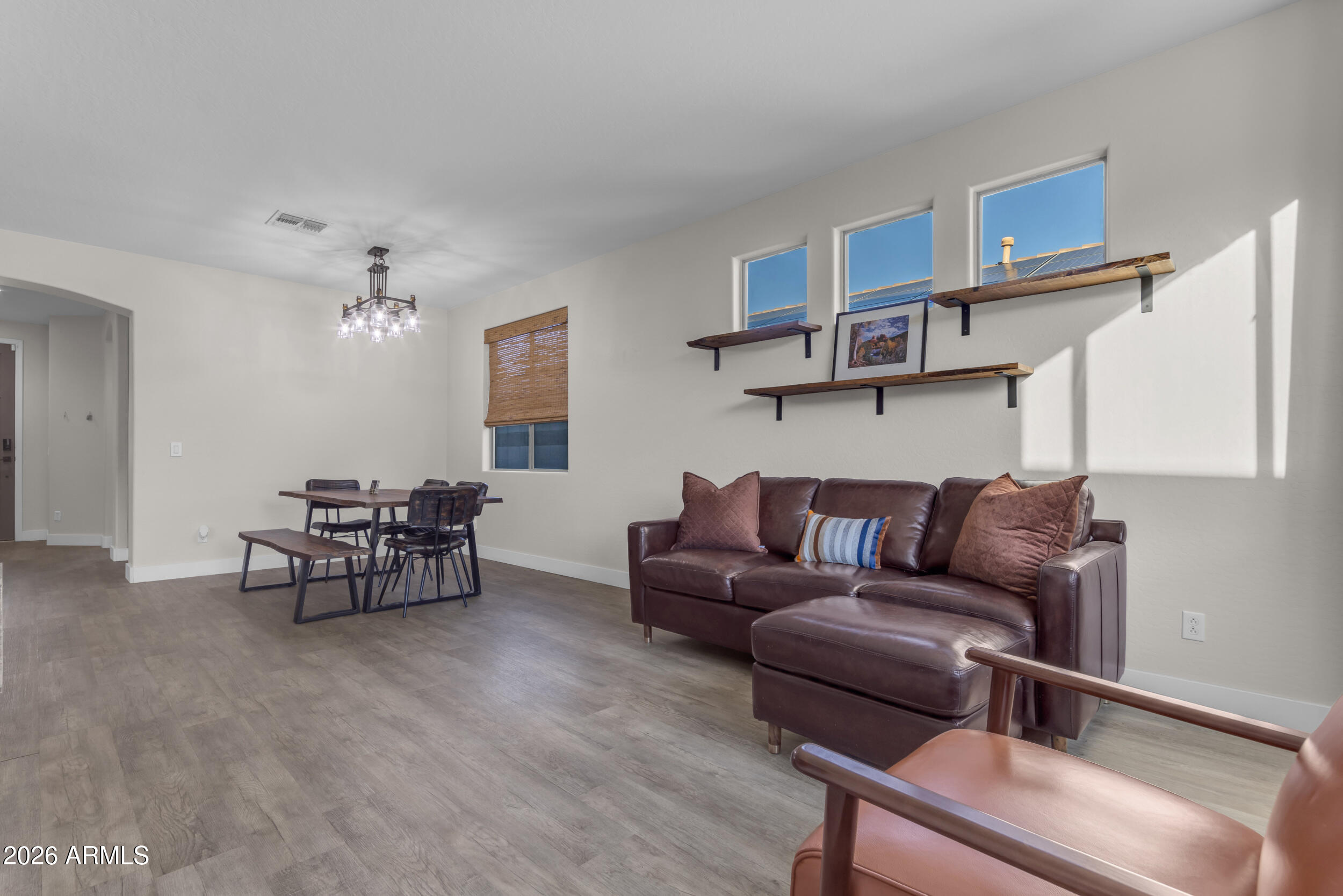 18115 West Cardinal Drive Goodyear, AZ 85338 - Photo 19 of 88 a living room with furniture and a wooden floor