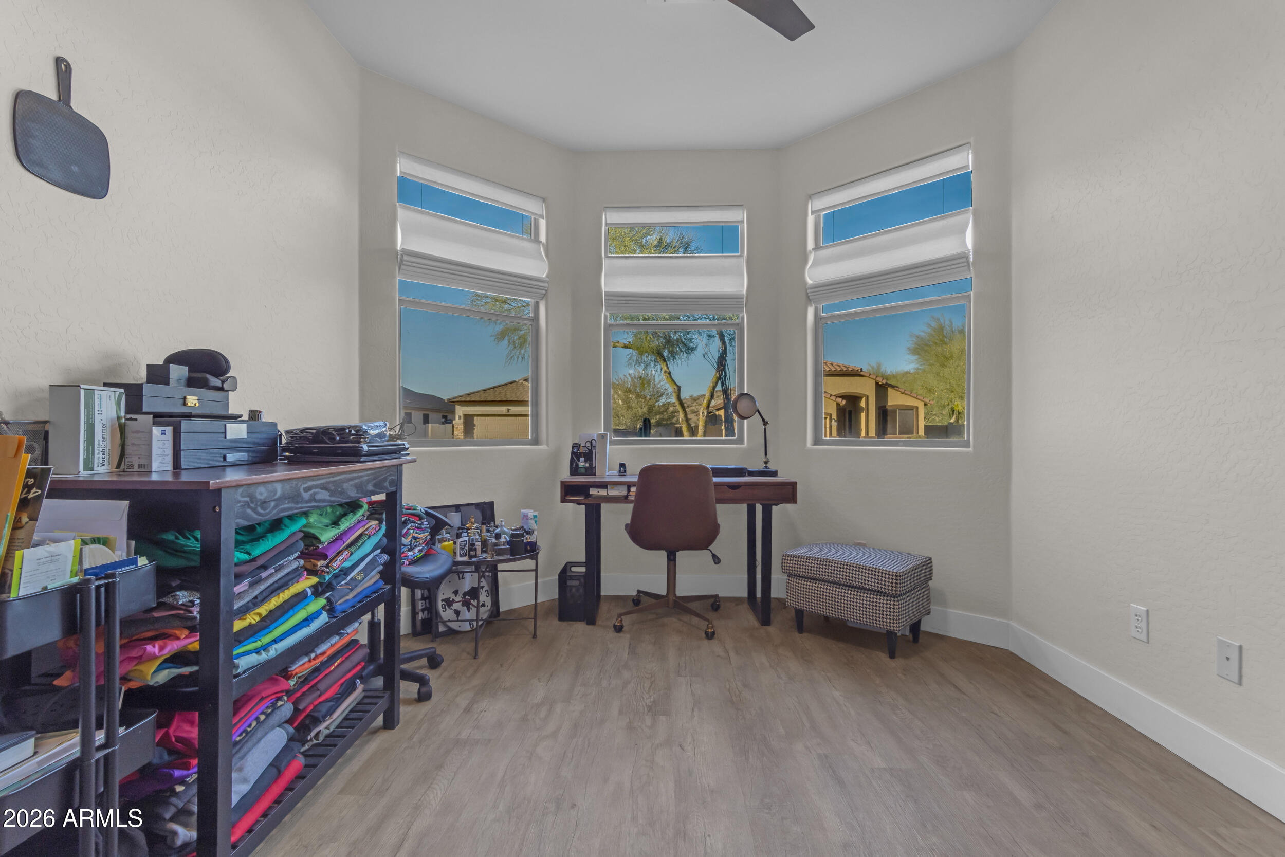 18115 West Cardinal Drive Goodyear, AZ 85338 - Photo 22 of 88 a living room with lots of furniture and a book shelf