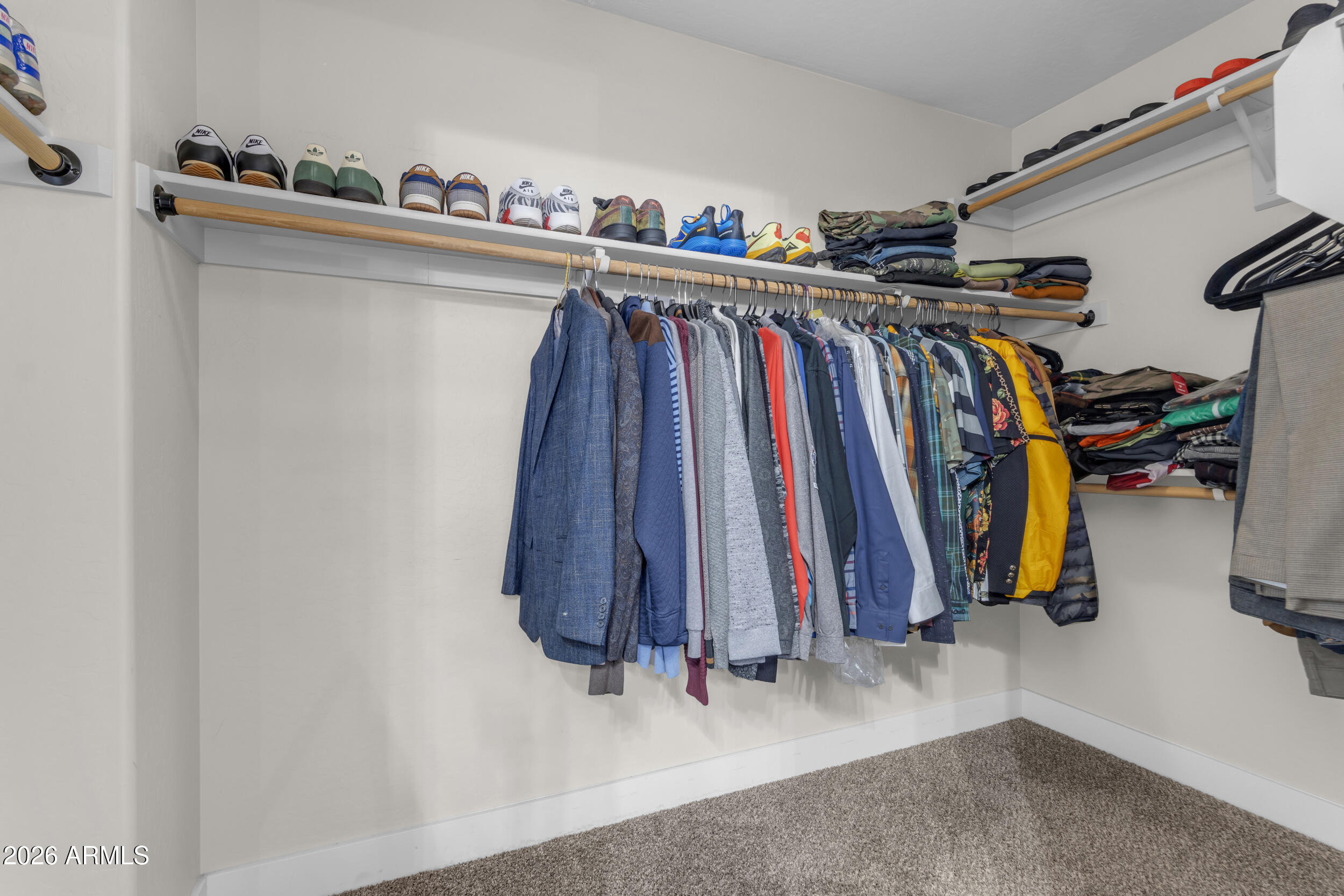 18115 West Cardinal Drive Goodyear, AZ 85338 - Photo 32 of 88 a view of walk in closet with clothes