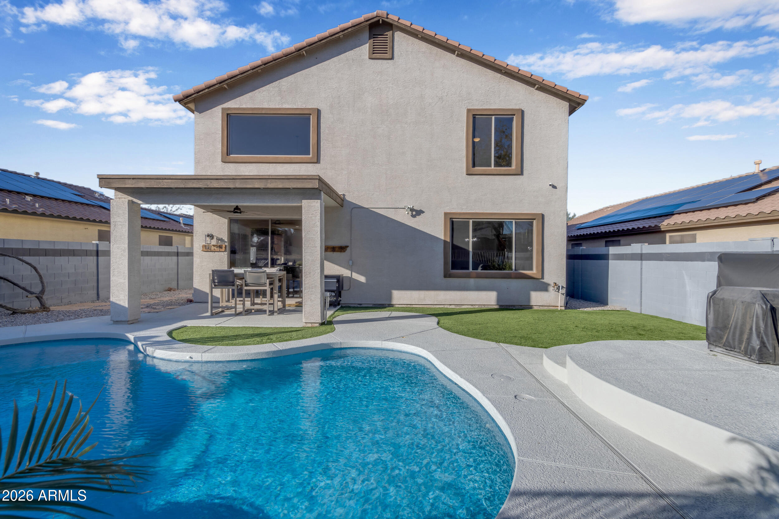 18115 West Cardinal Drive Goodyear, AZ 85338 - Photo 52 of 88 a front view of a house with swimming pool having outdoor seating