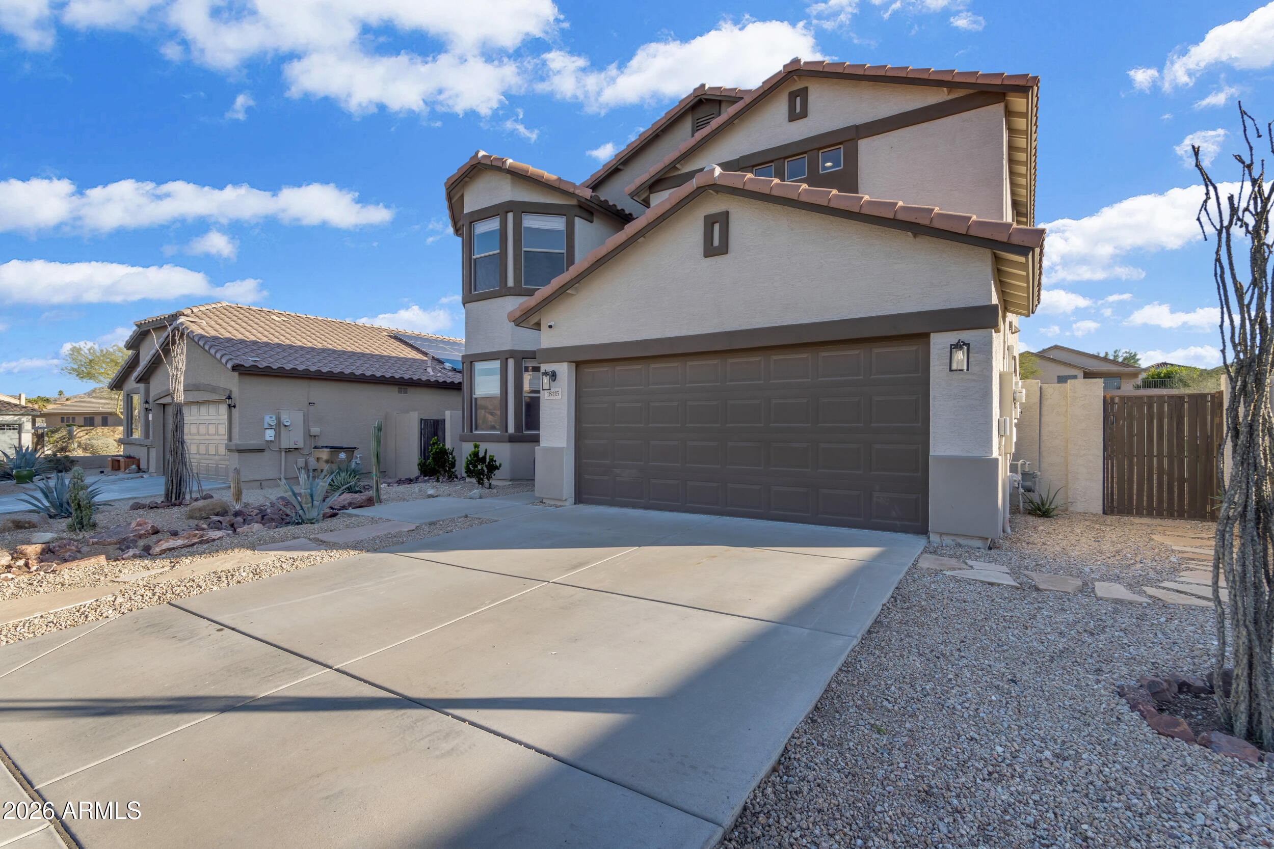 18115 West Cardinal Drive Goodyear, AZ 85338 - Photo 65 of 88 a front view of a house with yard