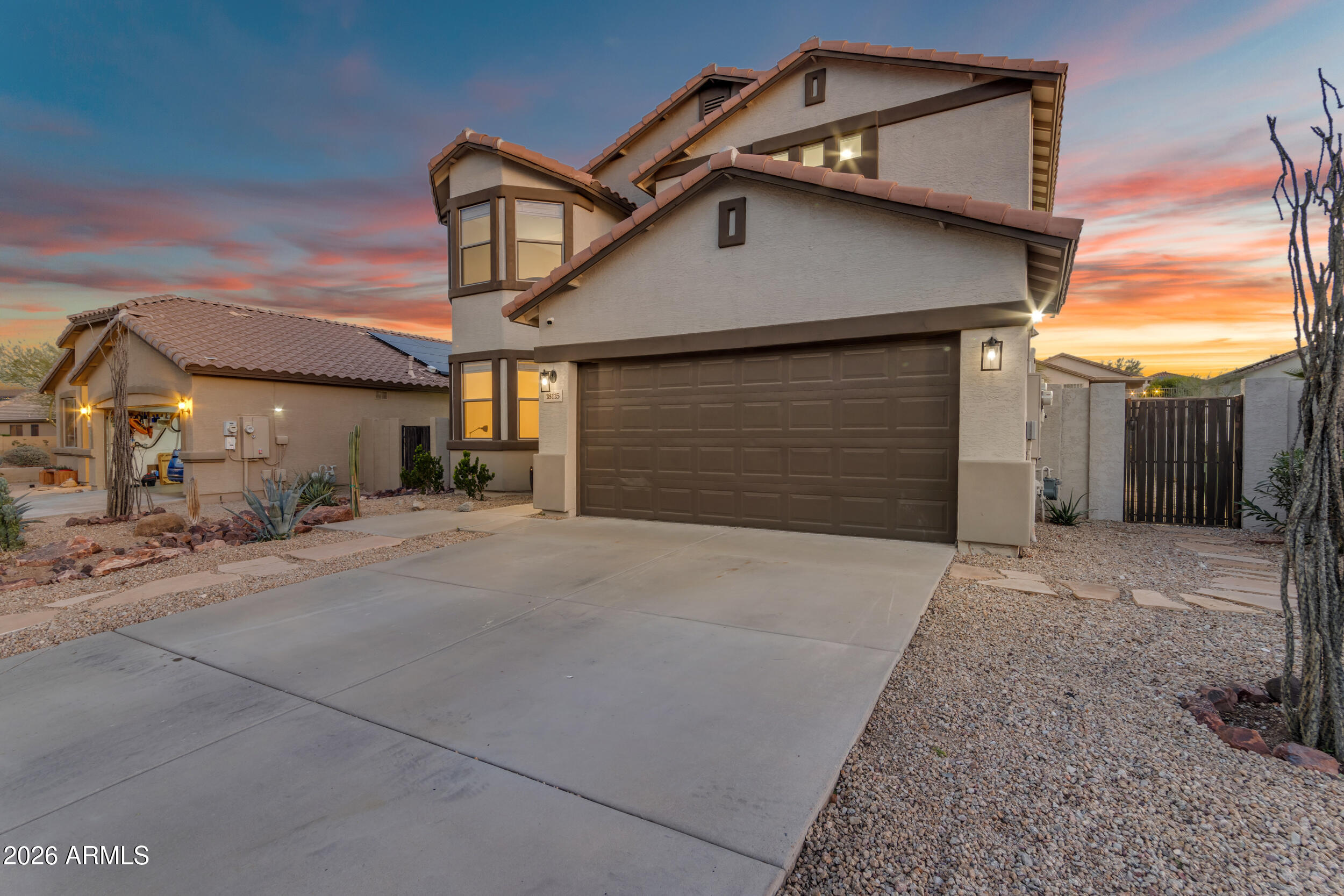18115 West Cardinal Drive Goodyear, AZ 85338 - Photo 83 of 88 a front view of a house with a yard and garage