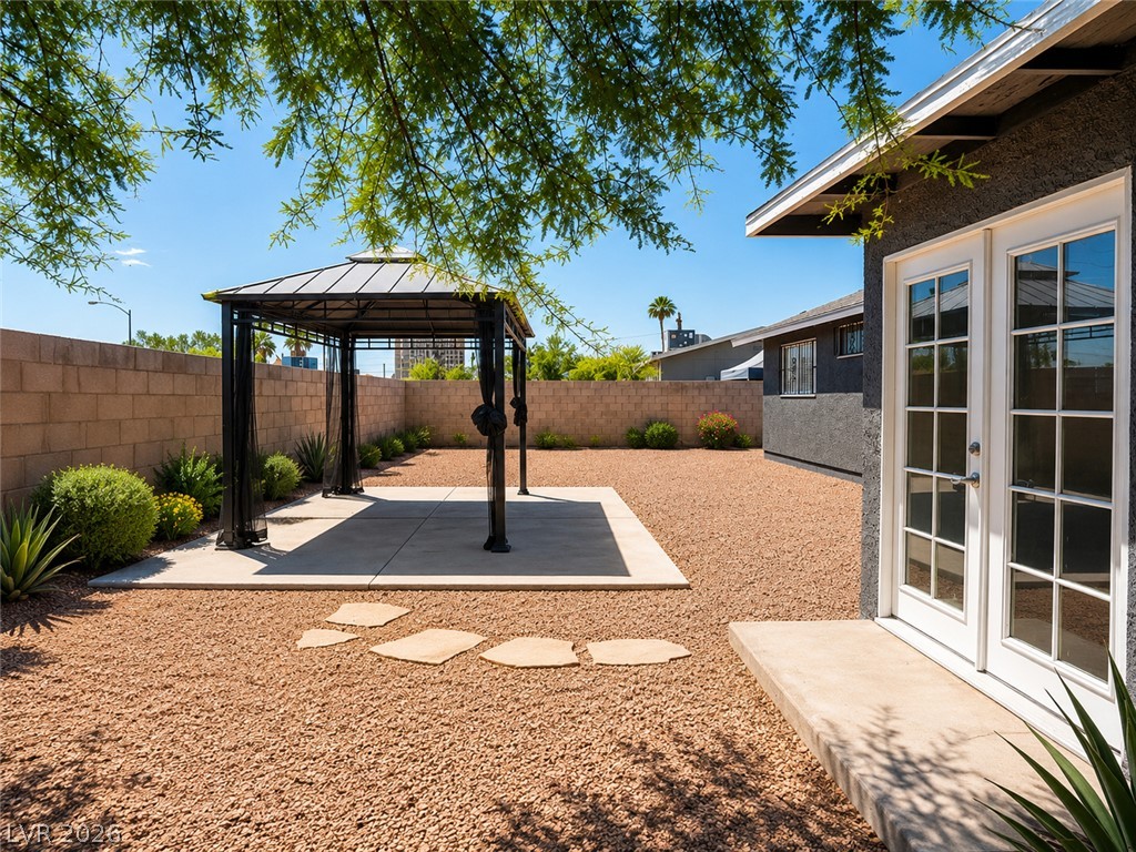 2870 South Sandhill Road Las Vegas, NV 89121 - Photo 5 of 64 A spacious, gravel-covered yard features a private gazebo, perfect for outdoor relaxation.