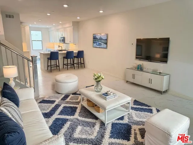 a kitchen with white cabinets and a stove with kitchen island