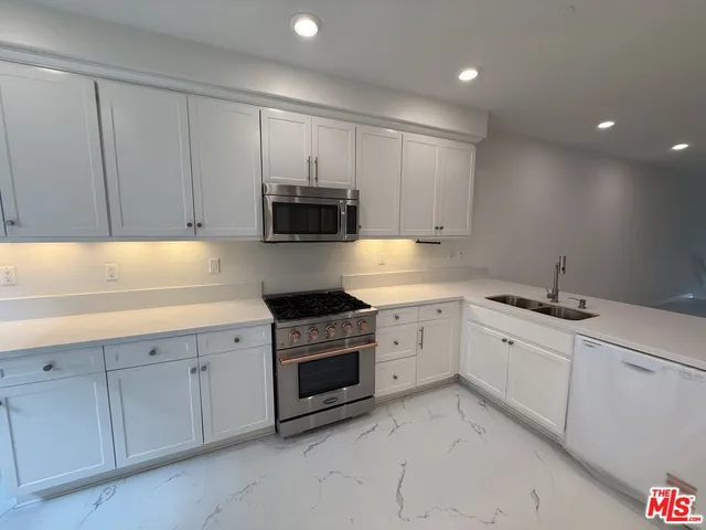 a view of an empty room and wooden floor
