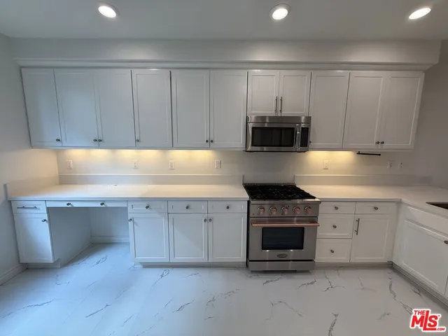a spacious bathroom with a double vanity sink and a mirror