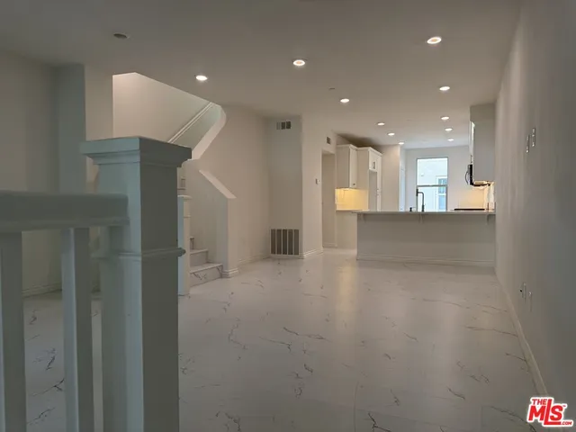 a view of a hallway with stairs