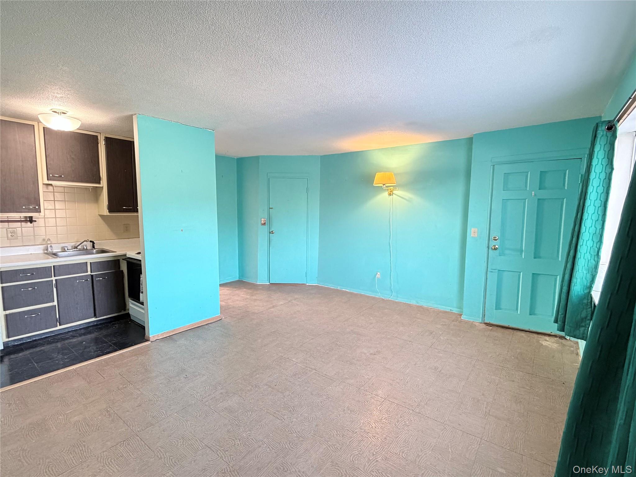 881 Albany Post Road, Unit 21 New Paltz, NY 12561 - Photo 3 of 19 a view of a kitchen with a sink and a refrigerator