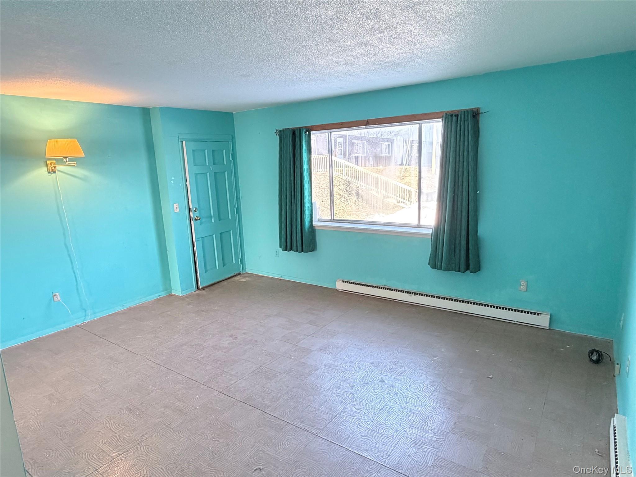 881 Albany Post Road, Unit 21 New Paltz, NY 12561 - Photo 6 of 19 a view of an empty room with a window